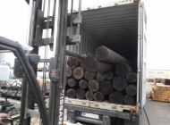 wooden poles loaded into 40ft containers